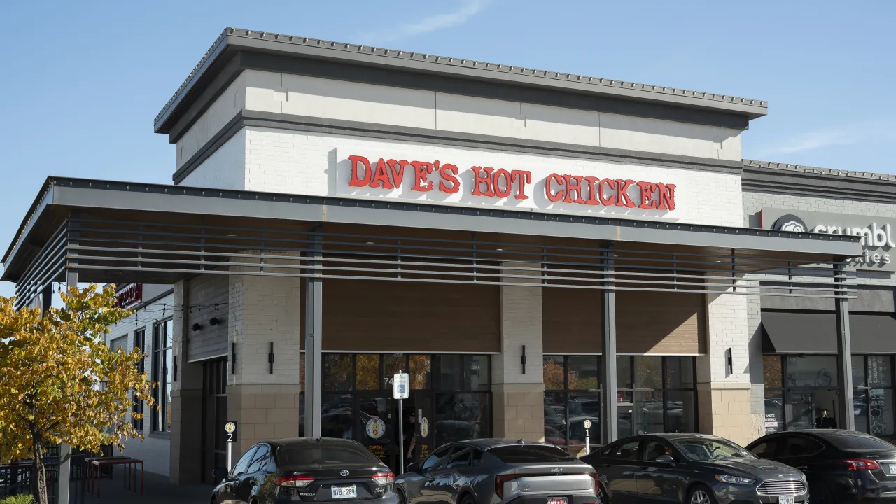 Exterior view of Dave's Hot Chicken on S. Olympia Avenue, Tulsa, OK, showcasing bold signage and modern architecture.
