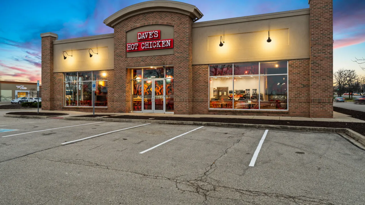 Exterior view of Dave's Hot Chicken at 2650 N. Fairfield Road, Beavercreek, OH, featuring vibrant signage and large windows.