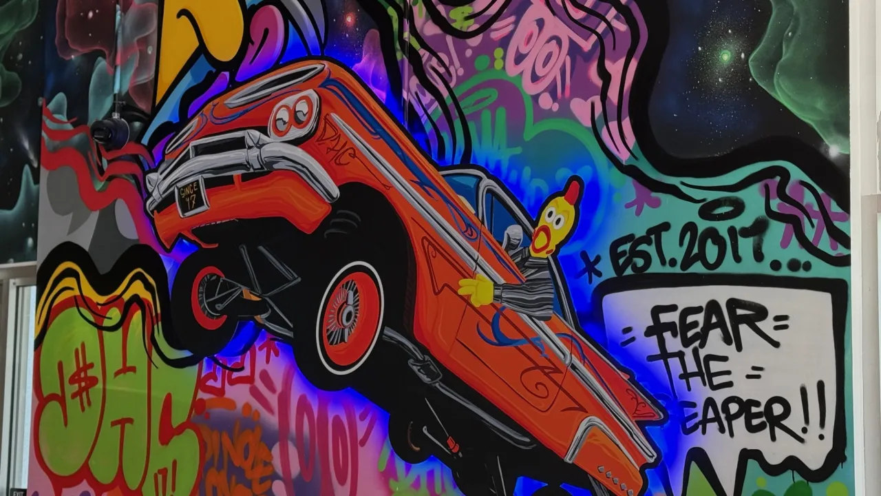 Interior mural at Dave's Hot Chicken on Pinole Valley Rd, Pinole, CA, featuring colorful graffiti art and a vintage car.