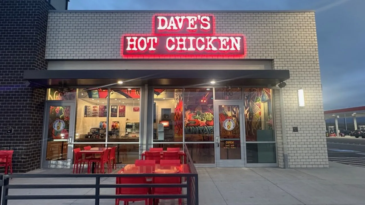 Exterior view of Dave's Hot Chicken at 6235 Sawcut Point, Fountain, CO, featuring bright red signage and outdoor seating.