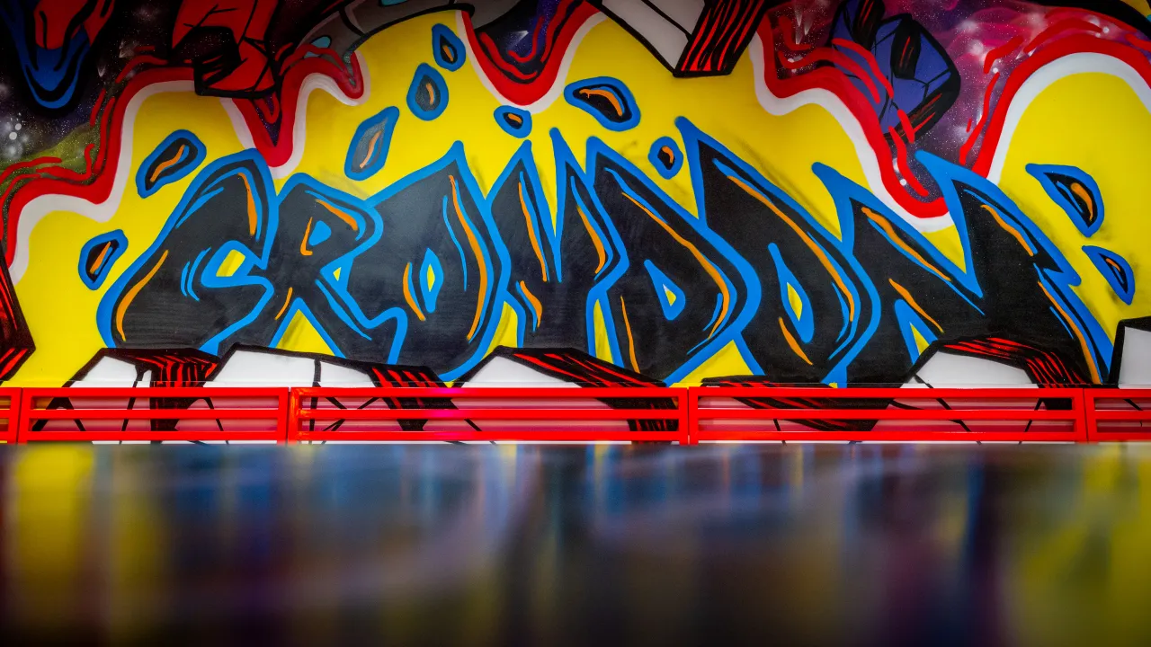 Interior view of Dave's Hot Chicken at 7/11 High St, Croydon, featuring vibrant graffiti art with 