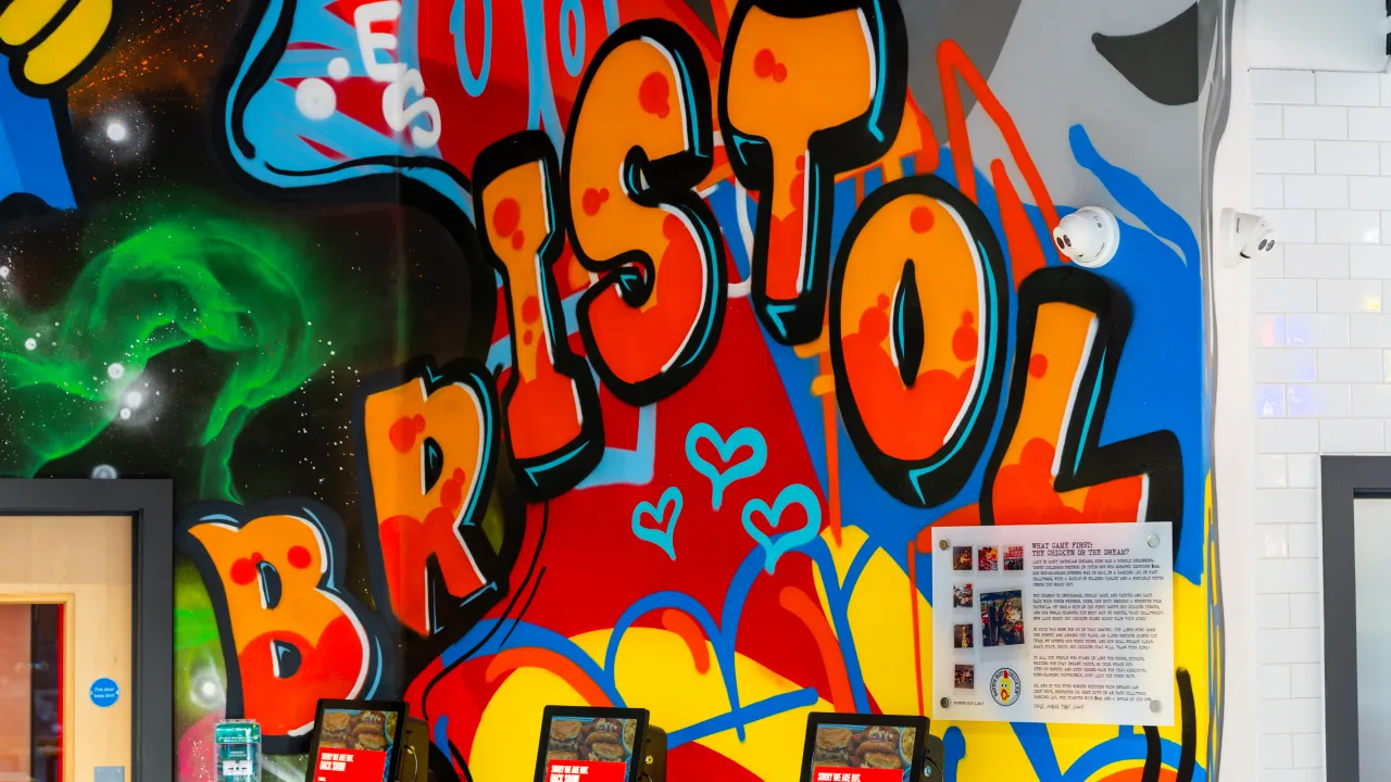 Interior view of vibrant mural at Bristol location, showcasing bold colors and artistic flair in an inviting atmosphere.