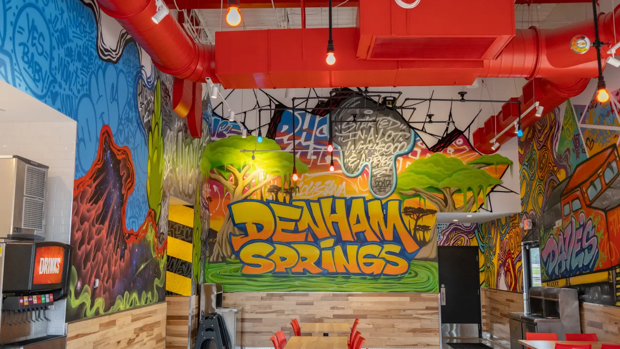 Interior view of vibrant mural at Denham Springs location, featuring bold colors and artistic elements in Denham Springs, LA.