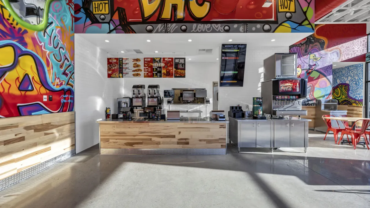 Interior view of the vibrant counter at 1102 Trust Ave, Augusta, GA, featuring colorful murals and modern decor.