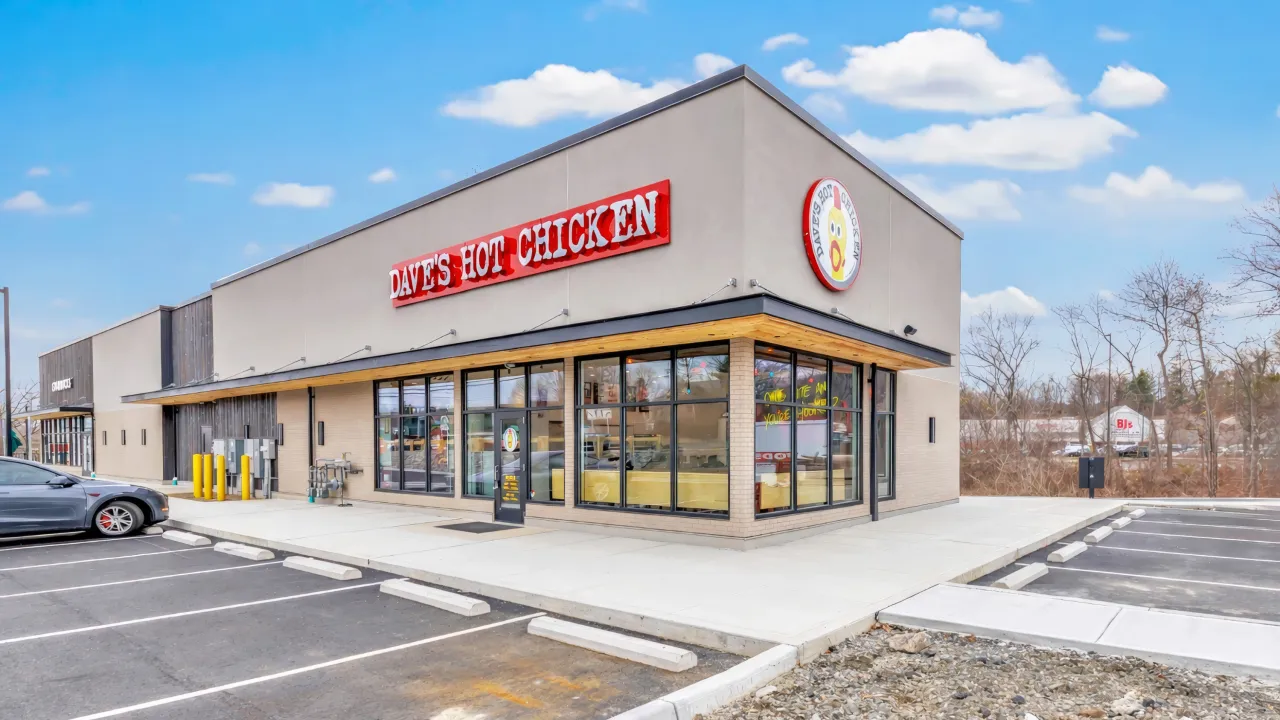 Exterior view of Dave's Hot Chicken on Federal Rd, Brookfield, CT, showcasing bold signage and large windows.