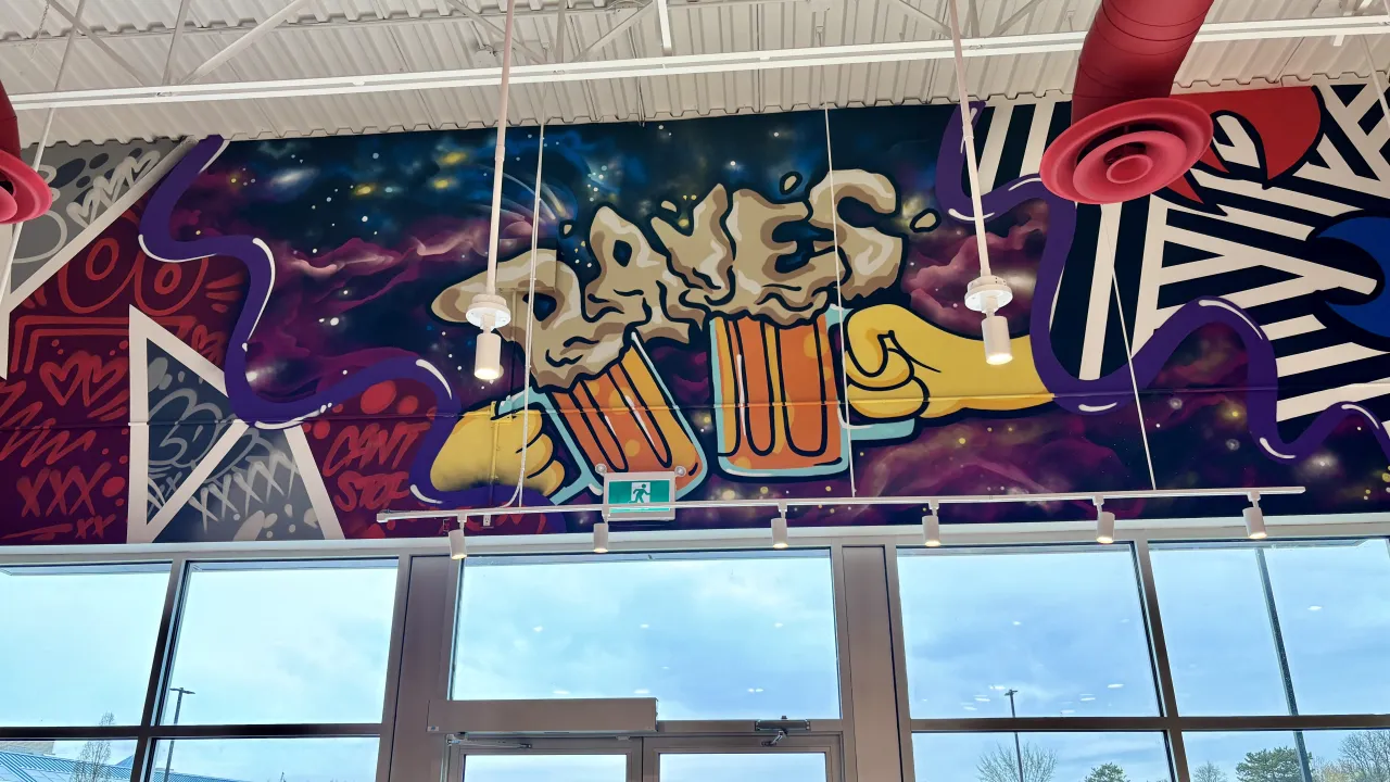 Interior view of vibrant mural at 765 Wonderland Rd. S., Unit 106-765, London, ON, featuring colorful beer imagery and dynamic designs.